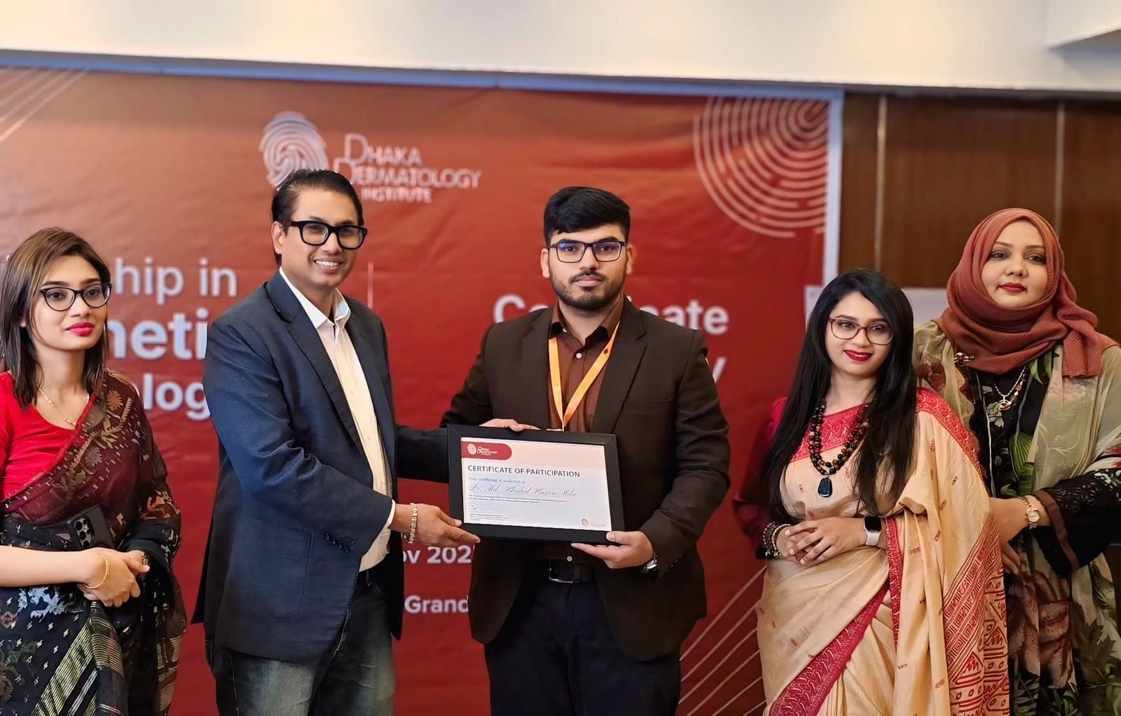 Dr. Khaled Hasan Milu receiving his Fellowship in Aesthetic Dermatology certificate