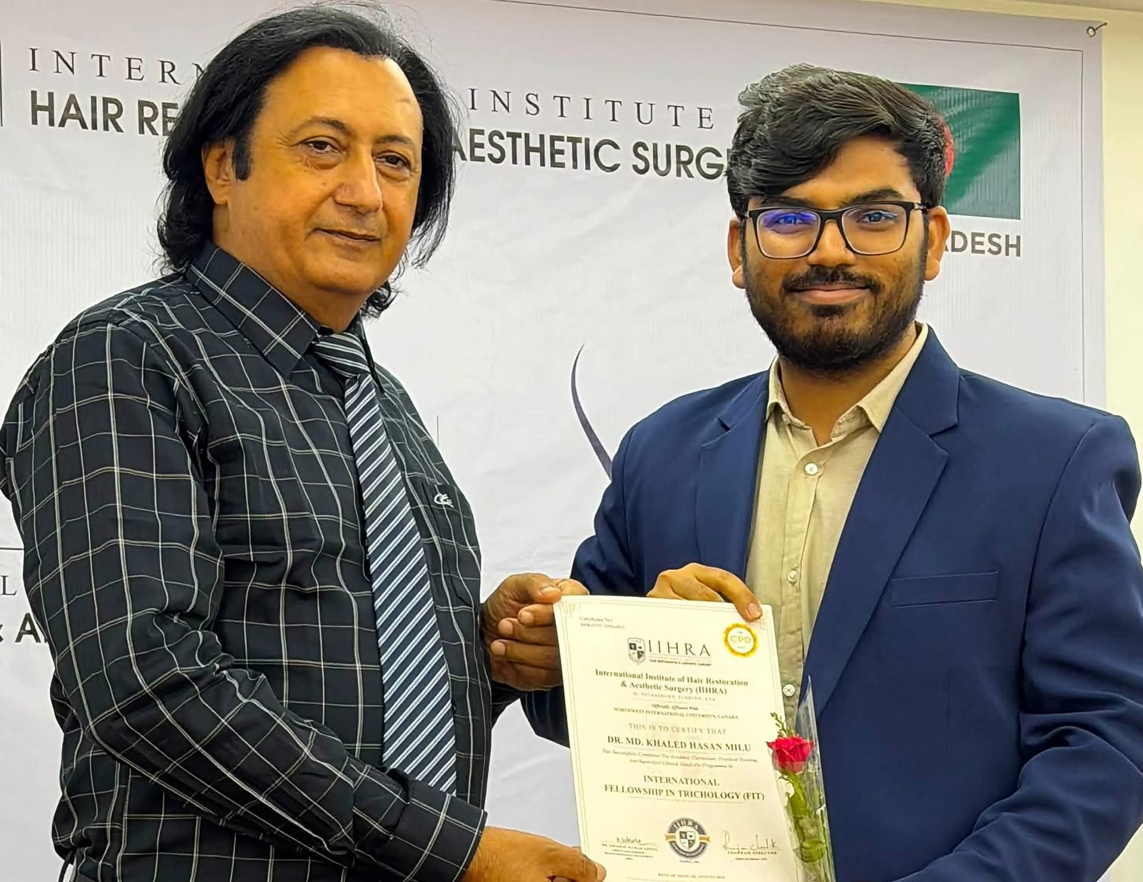 Dr. Khaled Hasan Milu receiving a hair transplant certificate from Dr. K. K. Arora