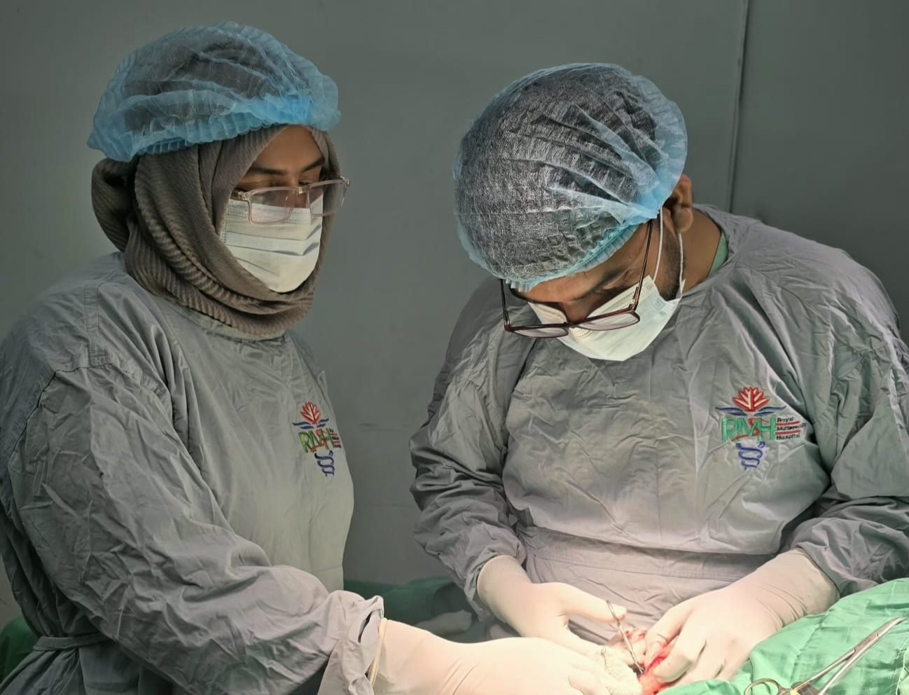 Dr. Khaled Hasan Milu and a colleague performing surgery at Royal Multispeciality Hospital