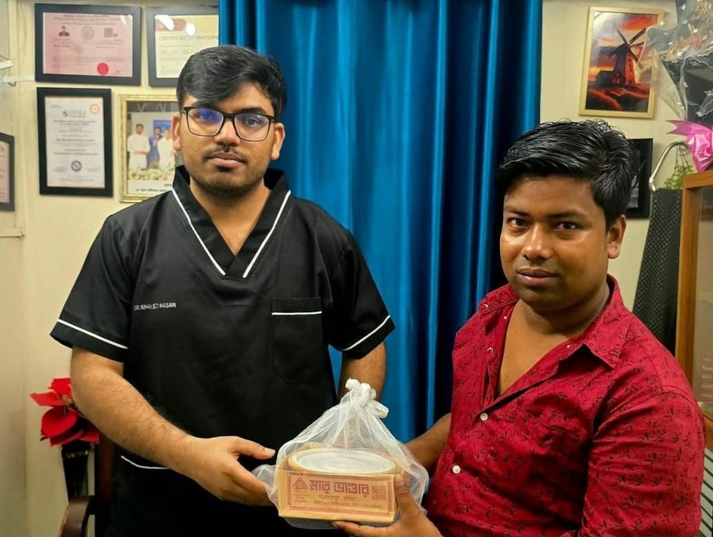 A recovered patient bringing Cumilla's famous rosomalai to Dr. Khaled Hasan Milu