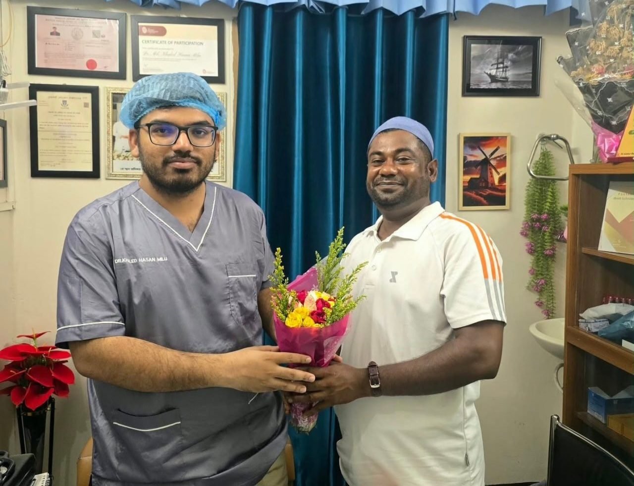 A patient who works in Oman presenting flowers to Dr. Khaled Hasan Milu