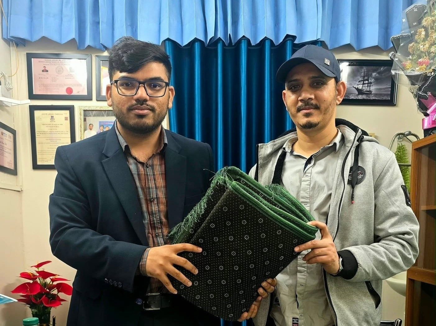 A patient presenting a prayer mat (jaynamaz) as a gift to Dr. Khaled Hasan Milu