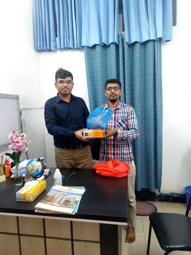 A grateful patient's family gifting Dr. Khaled Hasan Milu