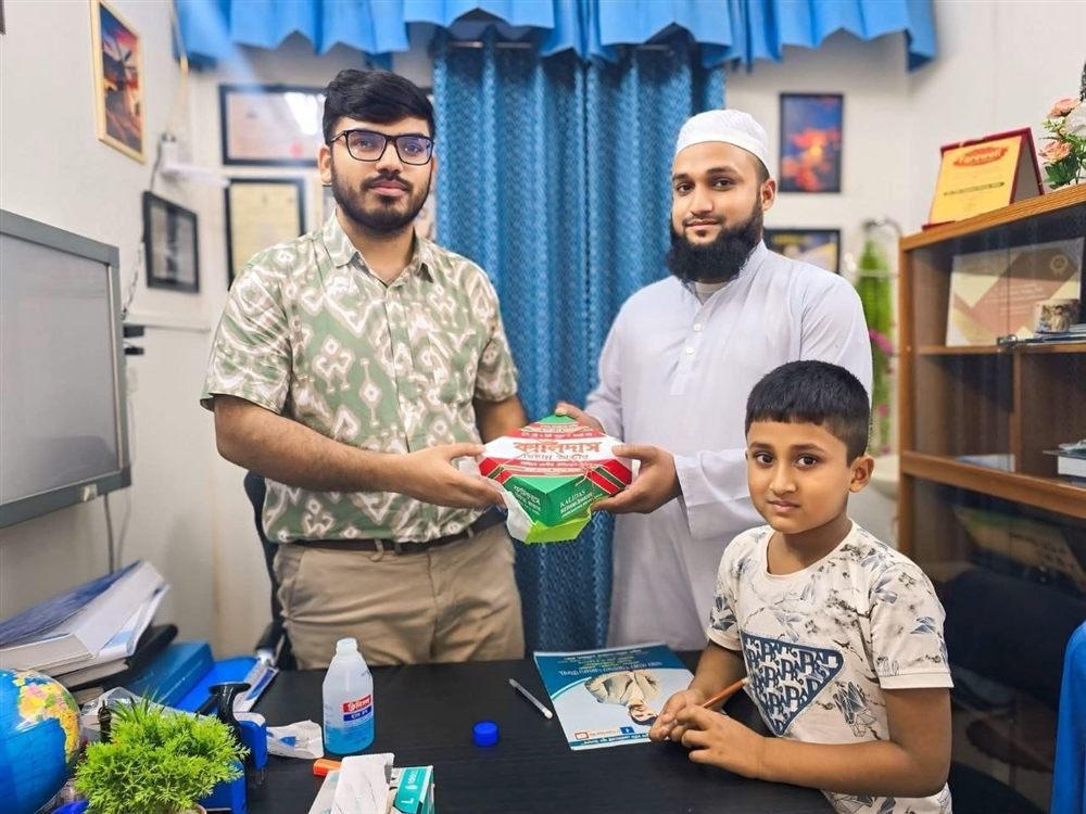 A patient's family, including a child, visiting Dr. Khaled Hasan Milu with gifts