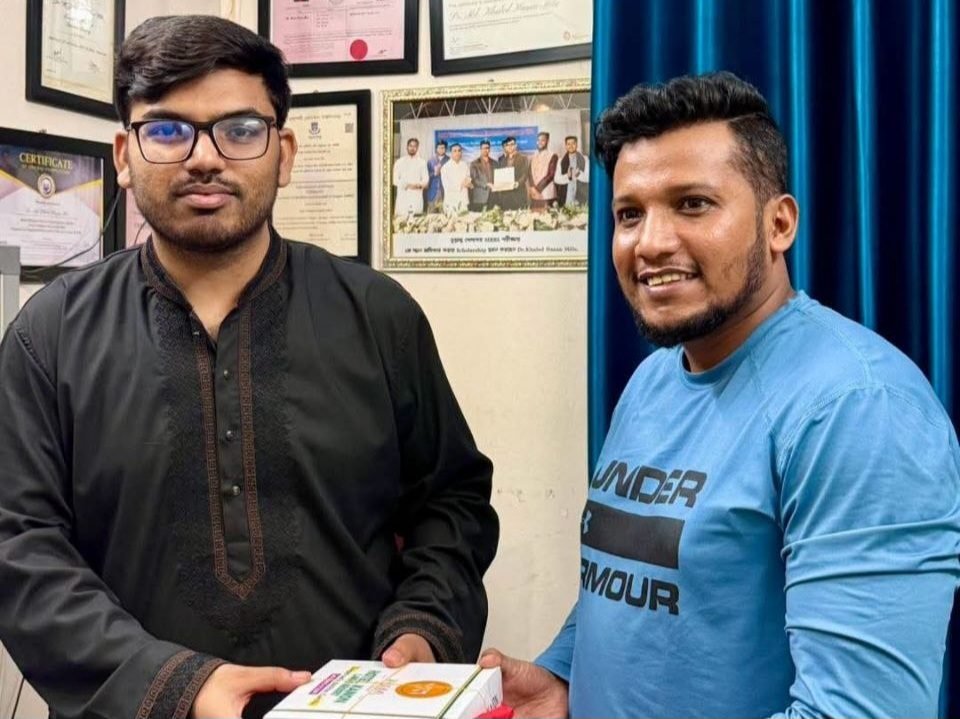 A recovered patient visiting Dr. Khaled Hasan Milu with a box of local curd